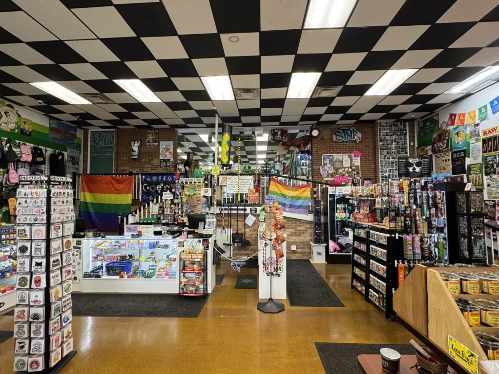Inside The Botany Bay Richmond KY smoke shop — colorful displays of bongs, glass pipes, vapes, rolling papers, stickers, and smoking accessories.